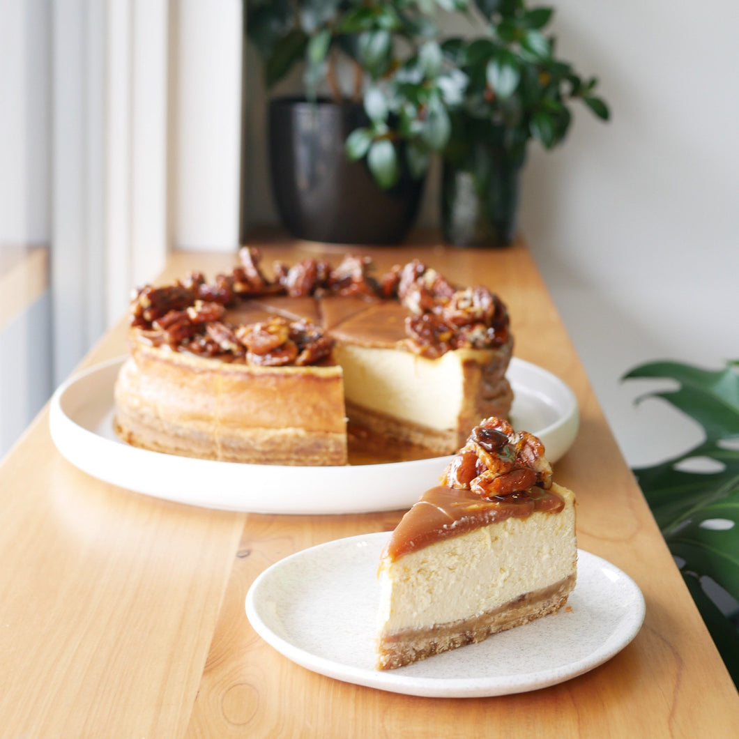 Delicious baked cheesecake with vanilla bean, salted caramel and candied pecans